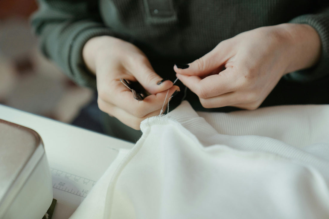 woman-hand-sewing-fabric
